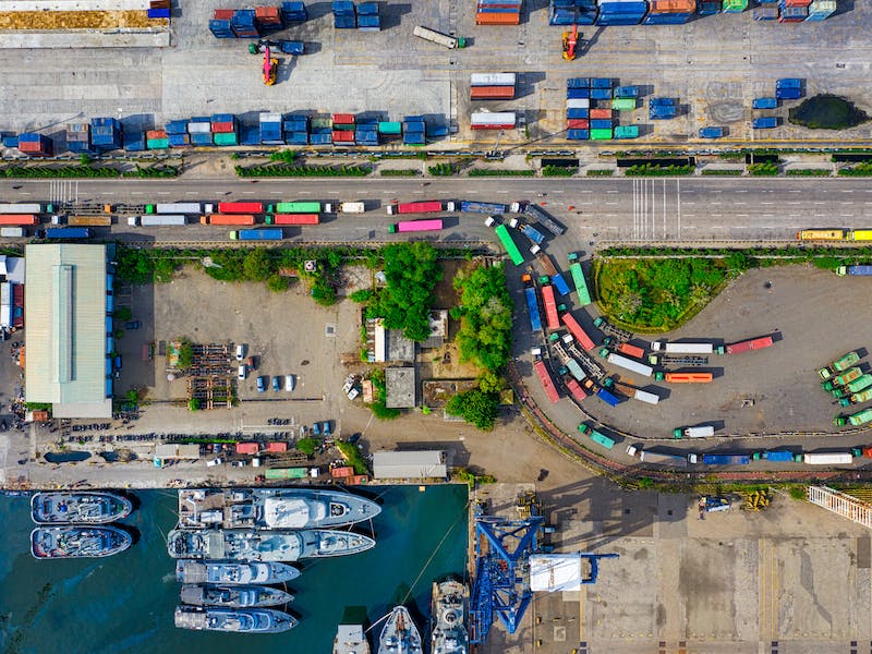 Ariel view of container trucks driving as part of order management system